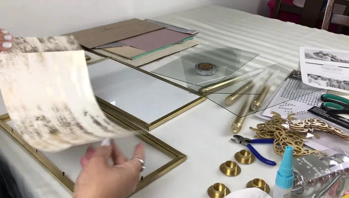 Prepare the top piece: Leave the tabs on one frame. Insert decorative paper and cardboard, then reinsert the glass.
