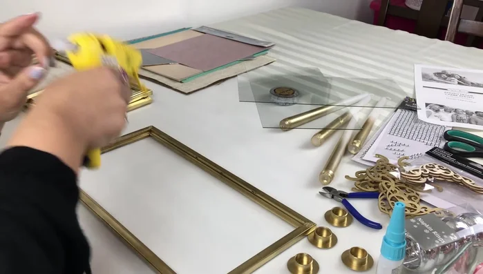 Assemble the side panels: Apply glue (Gorilla glue sticks recommended) to the corners of two frames (tabs removed). Insert the glass into the frames.