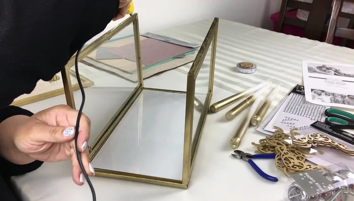 Attach the top piece: Apply hot glue to the top piece and attach it to the assembled base and side panels.