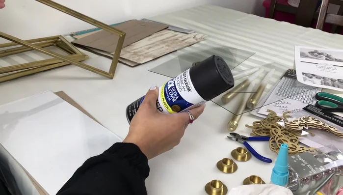 Prepare the frames: Spray paint all frames with black primer, followed by metallic gold spray paint.
