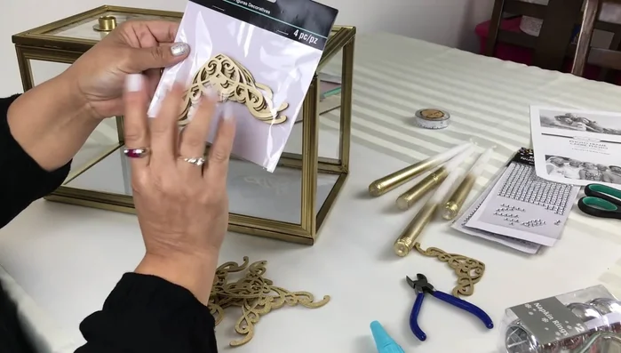 Add corner appliques (optional): Apply spray-painted gold corner appliques to each corner of the candelabra using hot glue.