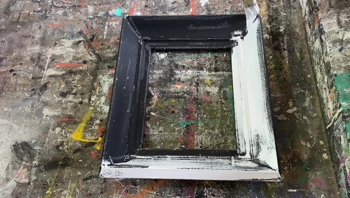 Gently scrape away some of the white paint in areas where wax remains, for further distressing.