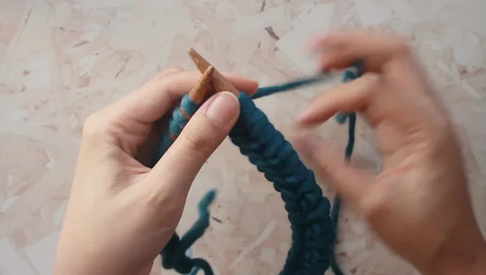 Remove the stitch marker from the left needle and place it on the right needle. Continue knitting.