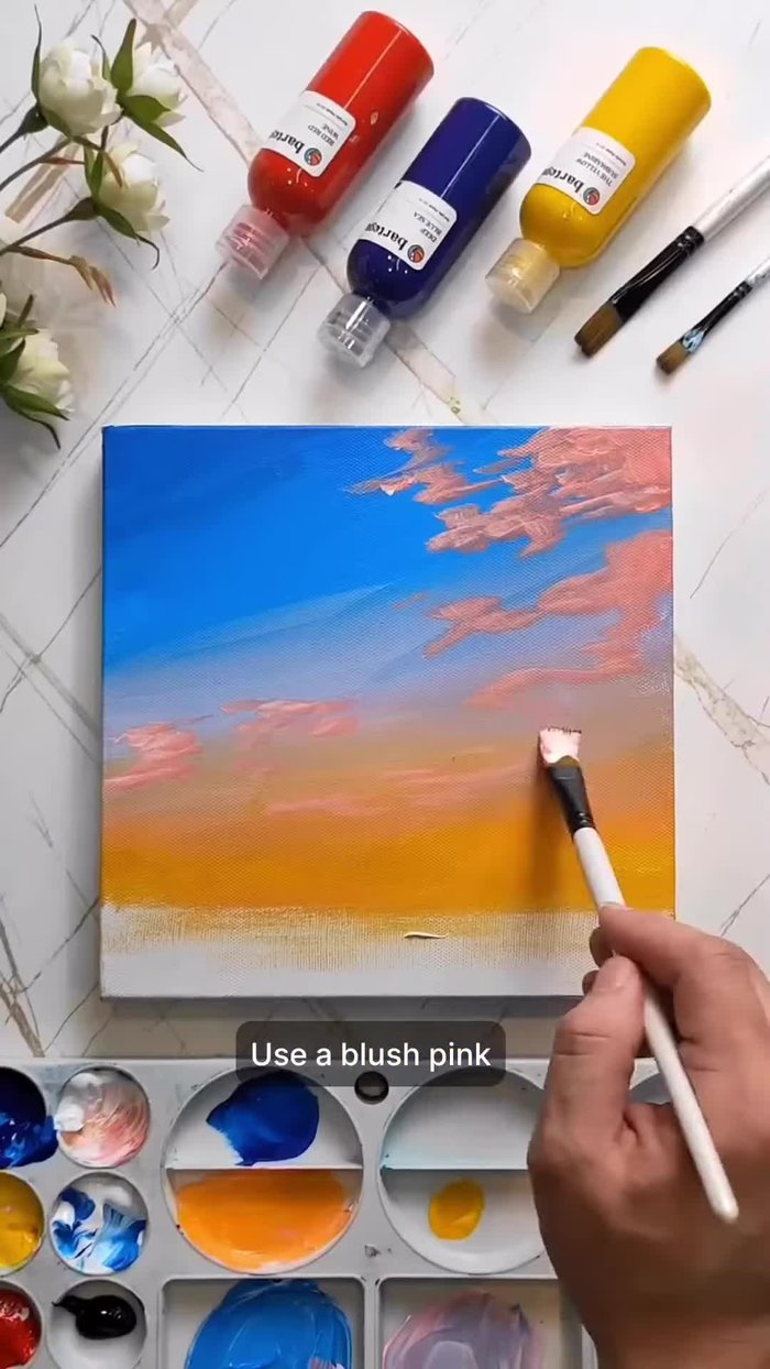 Paint the sunset sky using blush pink, then layer with bright orange.
