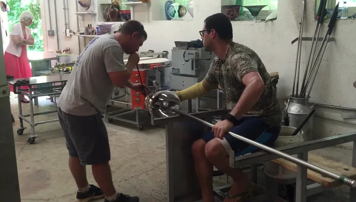 Apply final touch-ups to the lip, ensuring even heat distribution throughout the piece to prevent breakage.