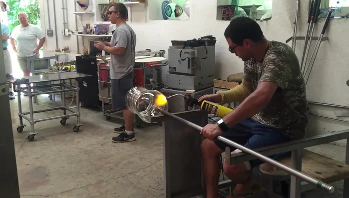 Apply final touch-ups to the lip, ensuring even heat distribution throughout the piece to prevent breakage.