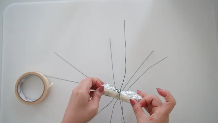 Secure the foil body with masking tape, leaving the bottom for legs, front for antennae, and top for wings.
