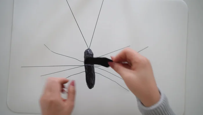 Glue a small oval black felt piece on top of the body where the wings will attach.