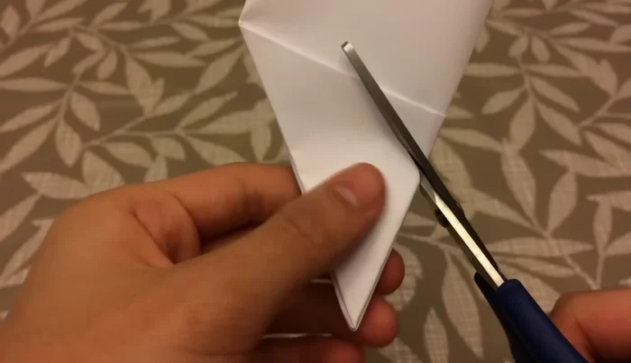 Cut out petals from the folded shape, ensuring the top remains flat. The number of petals increases with each layer (1,2,3,4).