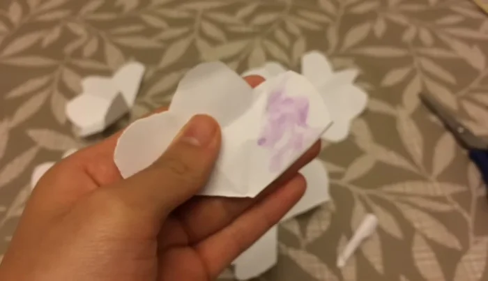 Assemble the rose by layering the petals, gluing the smaller petals inside the larger ones. 