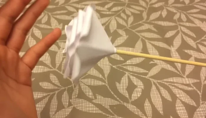 Optional: Insert a skewer or toothpick into the base of the rose to create a stem. Secure with tape if needed.