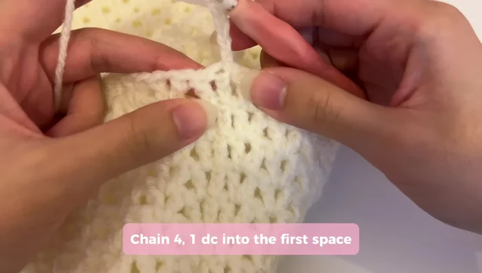 Continue creating rows for the straps, chaining two and turning at the beginning of each row. Repeat the V-stitch pattern, adjusting the last stitch to seamlessly connect to the bag.