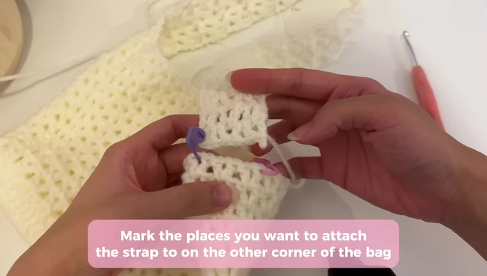 Attach straps to the bag by turning the bag inside out and working through marked stitches on the side. Slip stitch to join the strap and bag, repeating until the strap is attached. Fasten off and chain one for security.