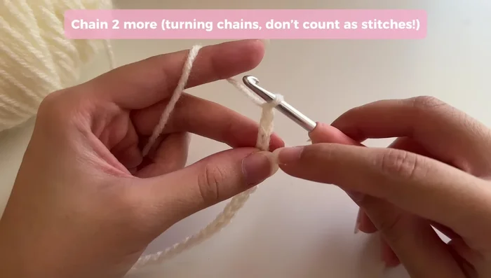 Repeat step 2 on the opposite side of the base, closing the gap as before, then work one double crochet into each remaining chain to complete the first round.