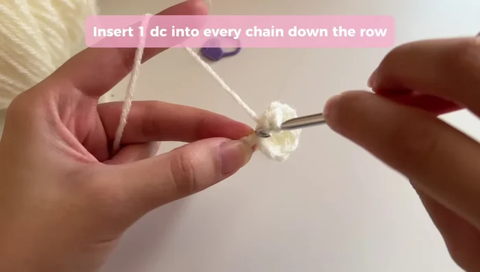 Repeat step 2 on the opposite side of the base, closing the gap as before, then work one double crochet into each remaining chain to complete the first round.