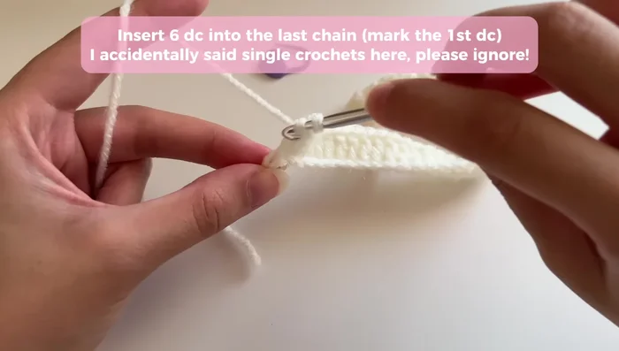 Repeat step 2 on the opposite side of the base, closing the gap as before, then work one double crochet into each remaining chain to complete the first round.