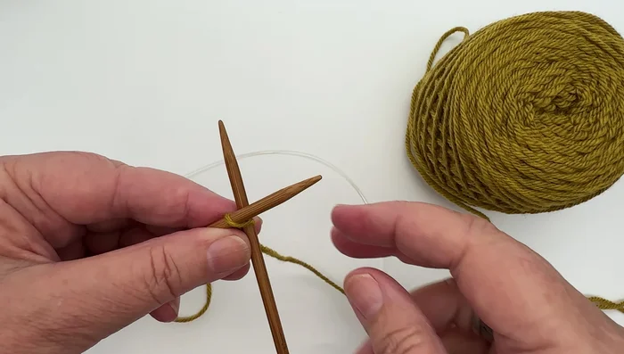 Slide the loop onto the left-hand needle.