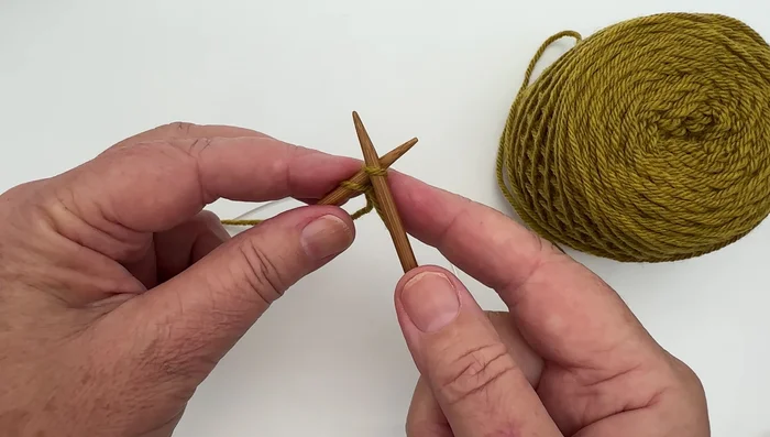 Slide the loop onto the left-hand needle.