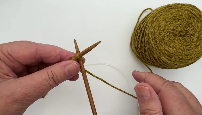 Subsequent Cast On Stitches: Insert the right-hand needle between the previous stitch and the newly cast-on stitch. Wrap the working yarn over the right-hand needle, pull it through to create a loop, and slide the loop onto the left-hand needle. Repeat.