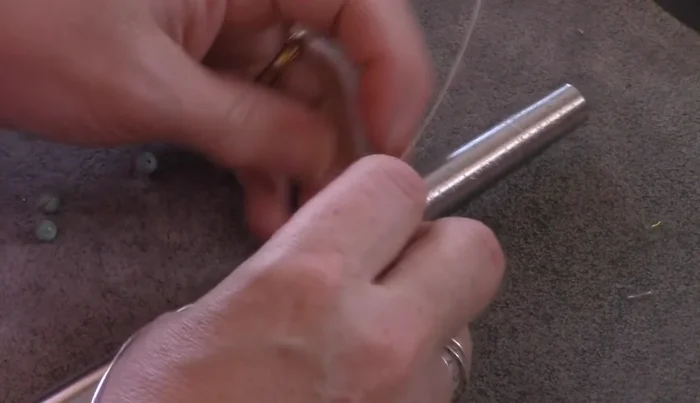 Continue wrapping until the wire is used up, maintaining consistent spacing between beads and keeping the wires close to the ring's base.