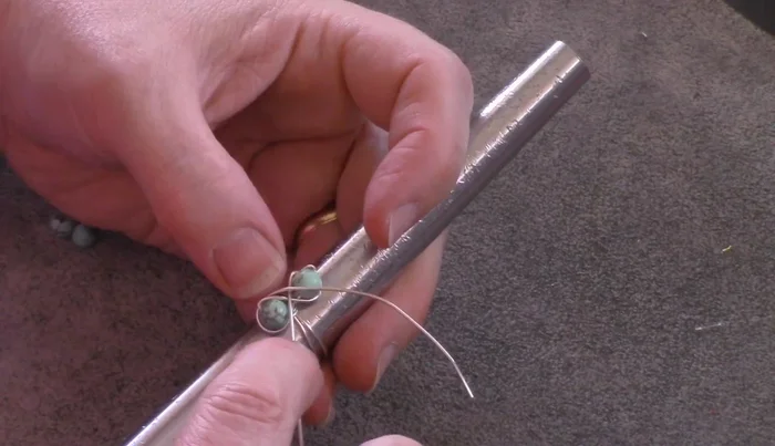 Continue wrapping until the wire is used up, maintaining consistent spacing between beads and keeping the wires close to the ring's base.