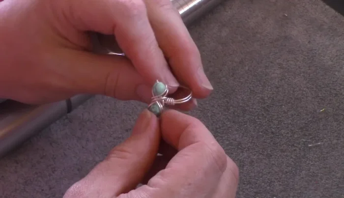 Finalize the ring size and shape: Place the ring back on the mandrel and use a hammer (rawhide or metal) to shape and size the ring to your desired fit. This also helps to harden the wire for durability.