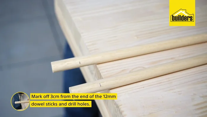 Mark and drill holes 3cm from the ends of the 12mm dowels.