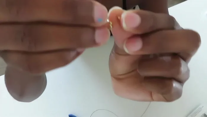 Close the crimp bead using pliers.