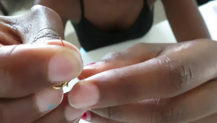 Close the crimp bead using pliers.