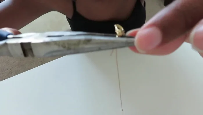 Close the crimp bead using pliers.