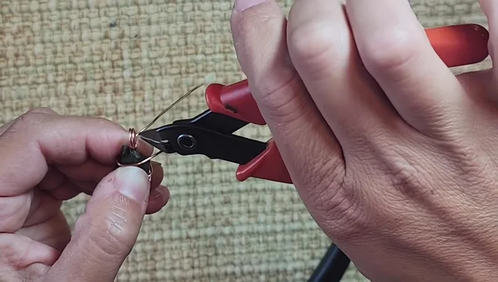 Pinch the cut wire ends with pliers to secure and prevent sharp edges.