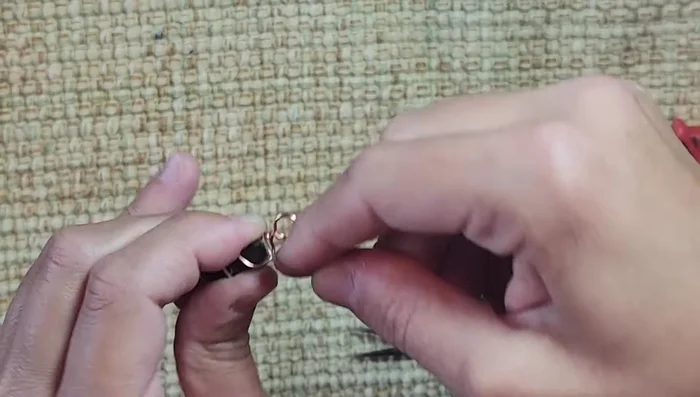 Wrap the wire around the bale several times to secure it further. Pinch the wraps with pliers for added stability.