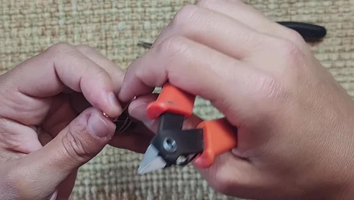 Finish the wrap, cut excess wire, and pinch the edges to ensure no sharp ends remain.