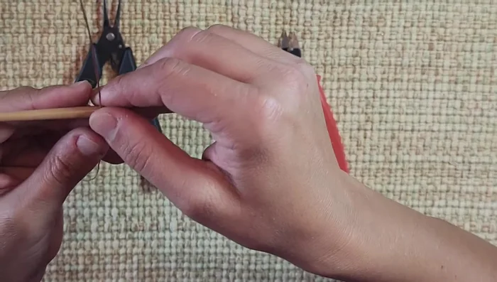 Create the bale: Wrap the wire around the paintbrush handle twice, tighten, and twist to secure. Reinforce with pliers.