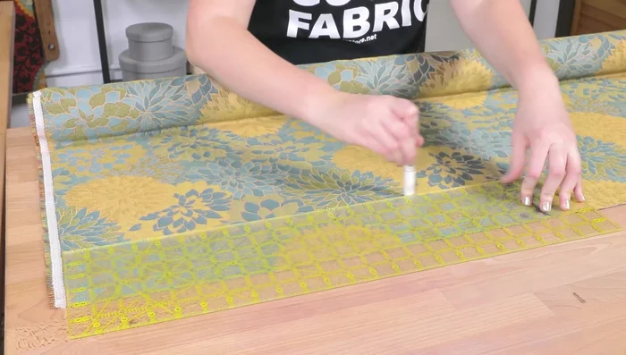 Cut the piping. The length should equal the cushion perimeter plus about 5 inches for joining. Width should be the cording width plus twice the seam allowance (example: 1.25 inches wide).