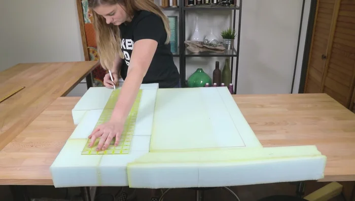 Attach Dacron cushion wrap to the foam using spray adhesive. Ensure the padding is smooth and free of bunching.