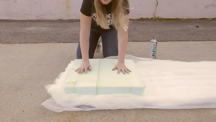 Attach Dacron cushion wrap to the foam using spray adhesive. Ensure the padding is smooth and free of bunching.