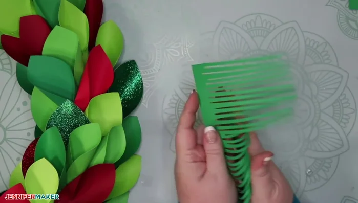 Add spruce sprigs and other decorations (optional) by curling the sprigs, gluing them at the base, and tucking them into the wreath.