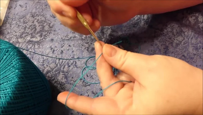 Create the knot: Wrap the thread around your index finger, pinch it between your thumb and middle finger, twist it once, and pull it through the loop to create a secure knot.