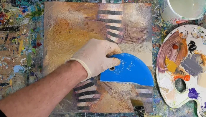 Use a silicone bull scraper or straight edge to create additional lines and direct the flow of the composition.