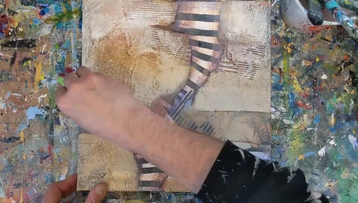 Sand the edges of the painting to darken them and create a frame effect.