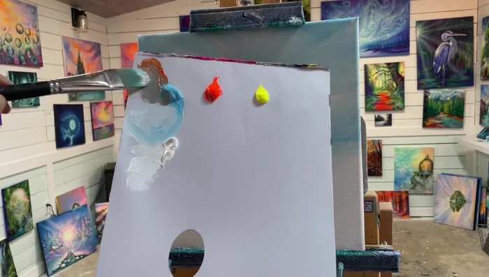 Add depth to the sunset: Apply smaller amounts of the orange-blue mixture lower on the canvas, creating perspective and making the clouds appear distant. Use white to create lighter tones and blend the colors.