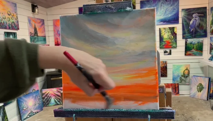 Add shadows: Mix orange and blue, then gradually add darker colors towards the bottom of the canvas to create shadows. Use a watered-down black mixed with neon orange to deepen the shadows at the bottom.