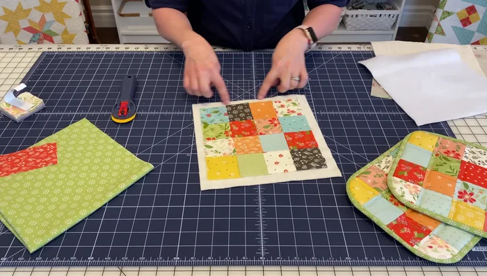 Prepare the batting and Insul-Bright layers: Cut 10x10 inch squares of batting. Sandwich the Insul-Bright between two batting layers.