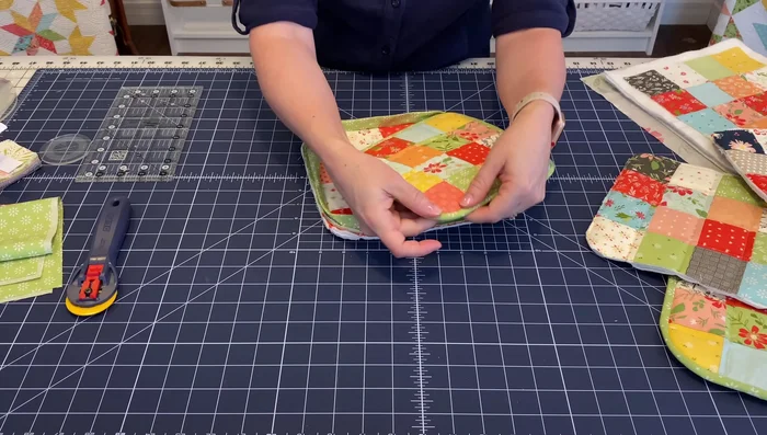 Reduce bulk from corners: To make sewing the binding easier, carefully trim some of the extra layers of batting and Insul-Bright in the corners. 