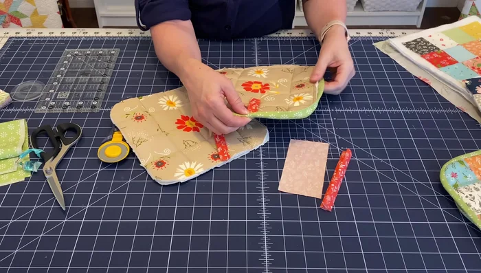 Attach the binding: Use clover wonder clips to secure the binding around the edge, overlapping it to the back. Hand sew or machine sew it (from the back) for a neat finish.