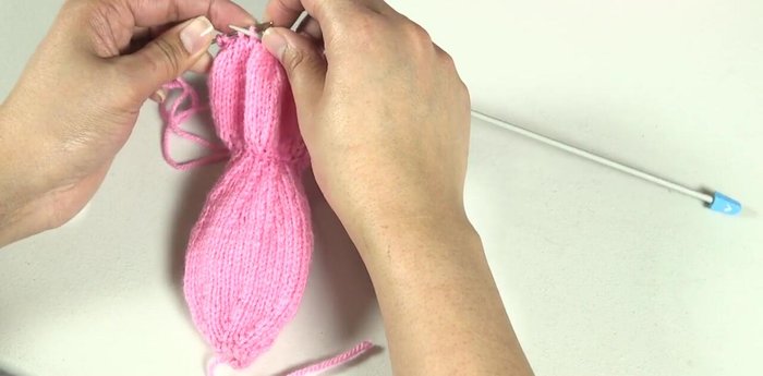 Thread the long yarn end through a blunt-ended needle and secure the gathered stitches with a tiny stitch.