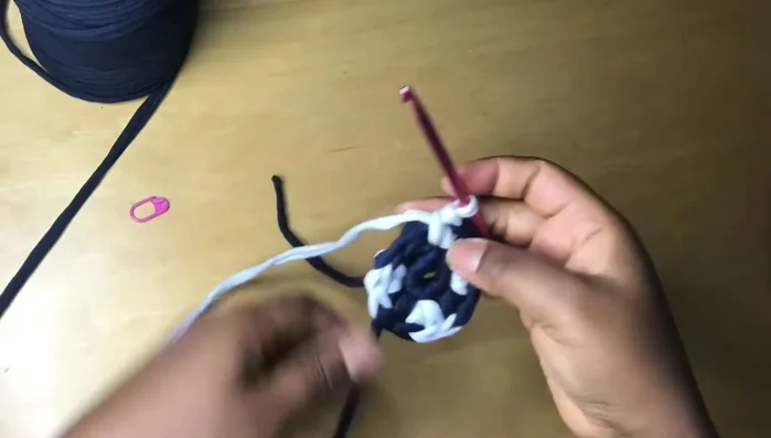 Continue the pattern of one single crochet in most stitches, two in the last stitch of each color section, changing colors as desired to create the spiral effect.