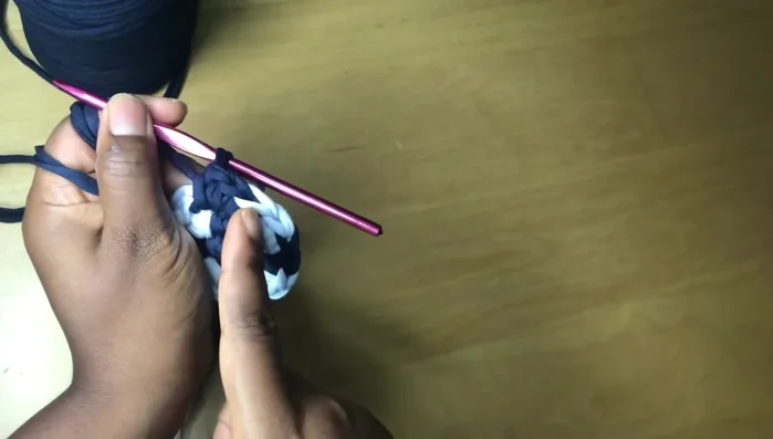 Continue the pattern of one single crochet in most stitches, two in the last stitch of each color section, changing colors as desired to create the spiral effect.