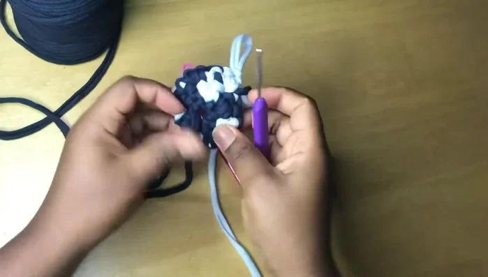 Cut the yarn, remove the stitch marker, and weave in loose ends using a yarn needle or crochet hook.